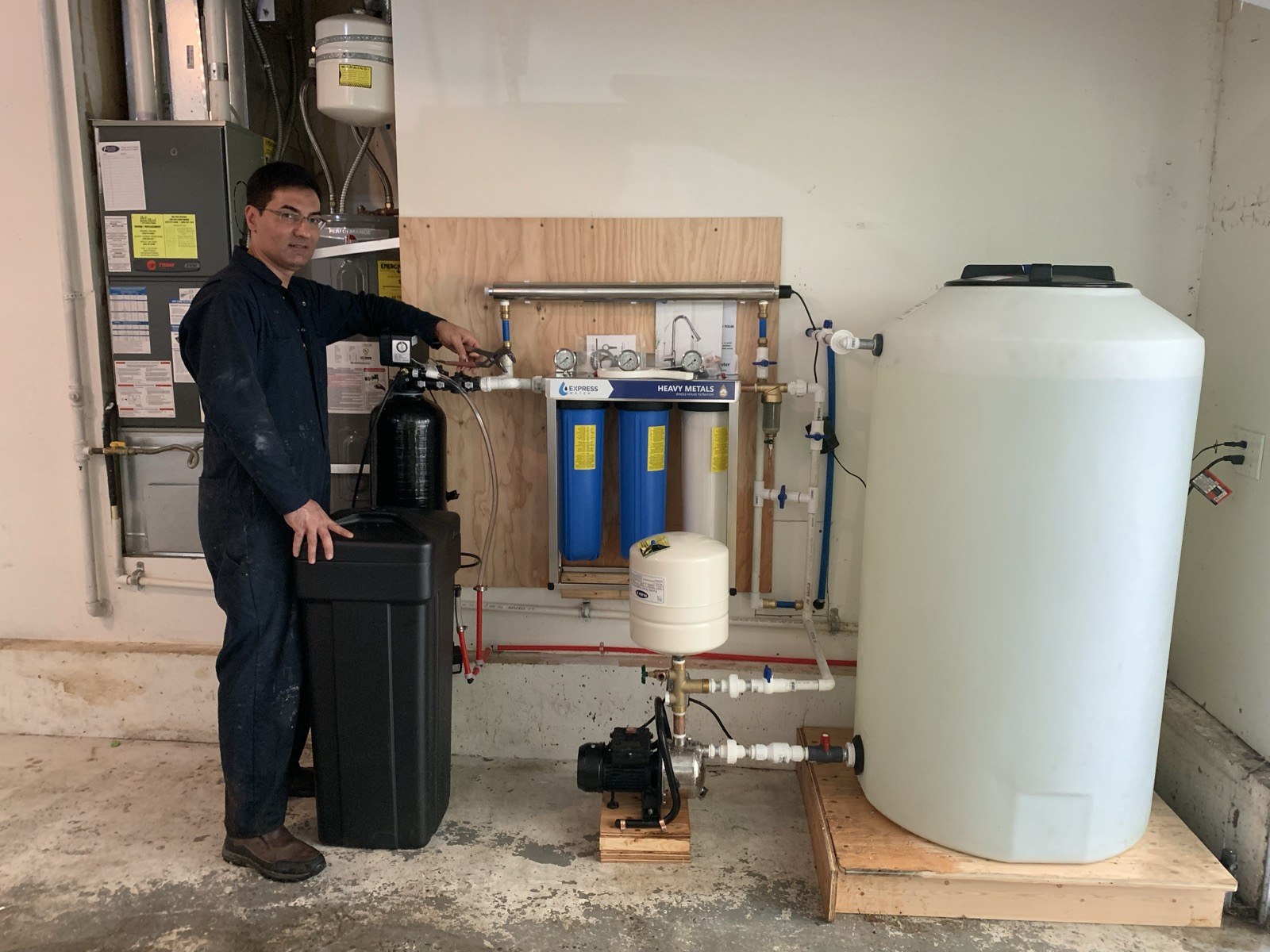 Technician standing beside a water-treatment installation