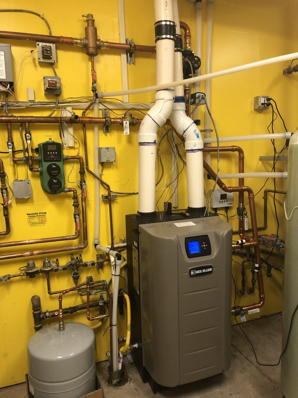 Hydronic heating system with a Weil-McLain boiler, copper pipework and an expansion vessel