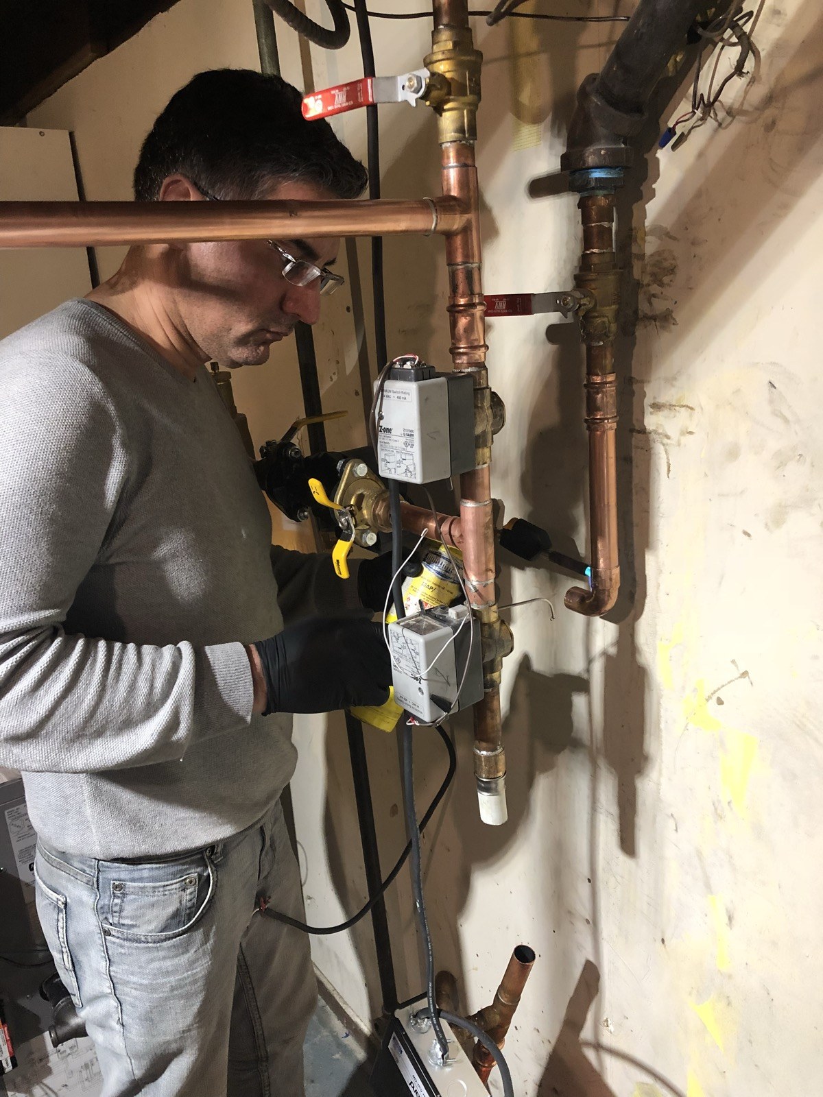Technician soldering a copper joint on hydronic heating pipework