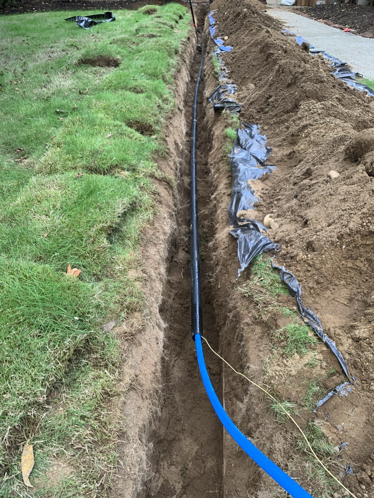 Blue water-supply pipe in an outdoor trench
