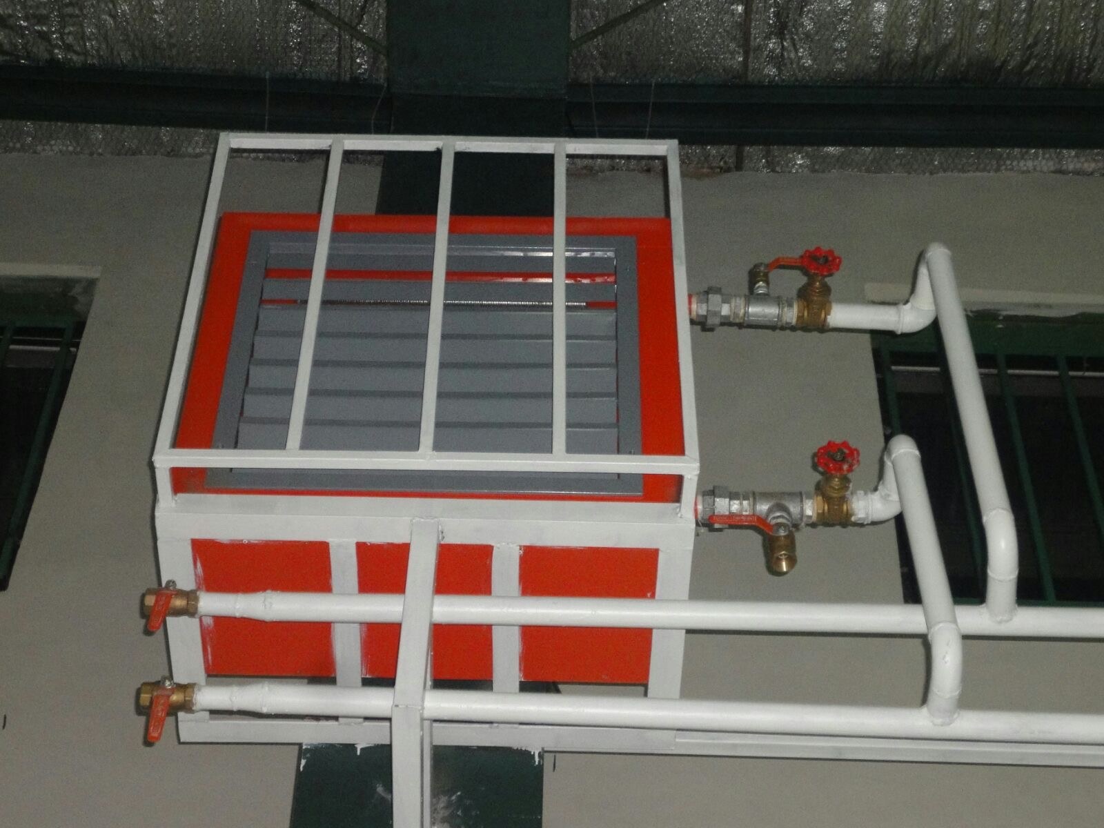 Piped unit heater inside a protective cage