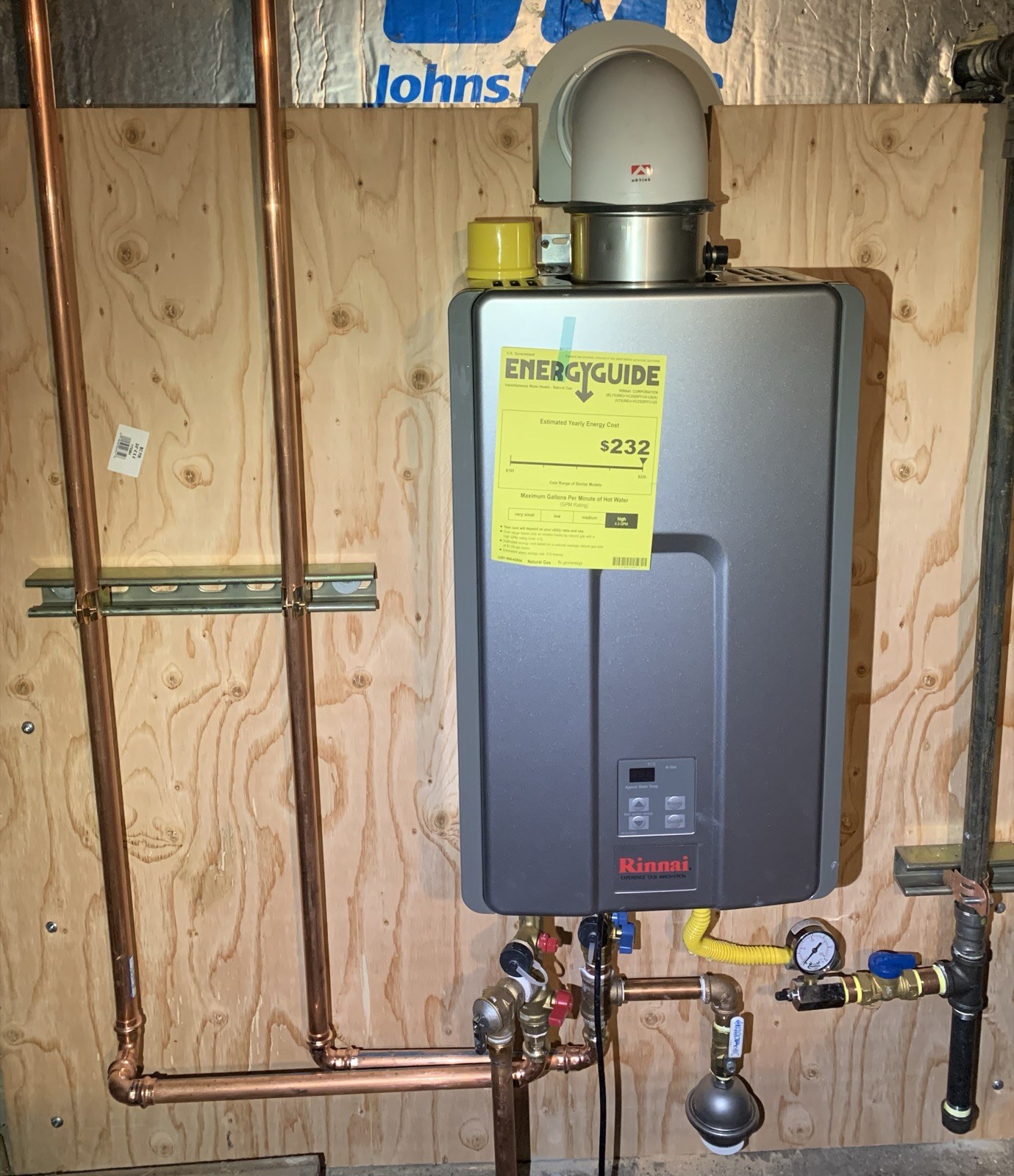 Rinnai gas tankless water heater with venting and connected pipework